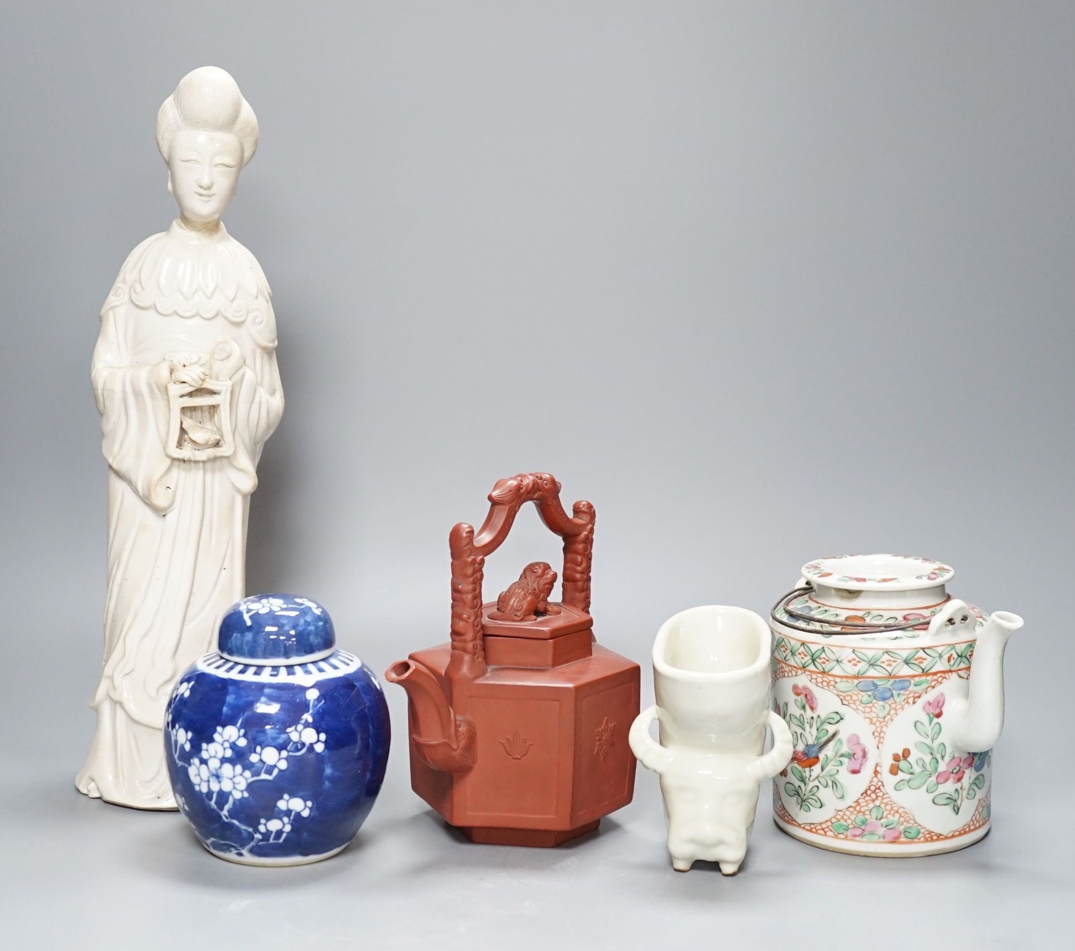 A Chinese blanc de chin figure of a lady with a bird, 37cm, together with a famille rose teapot, a yixing style teapot, blue and white jar and cover and a pale celadon ground ‘ox head’ libation cup